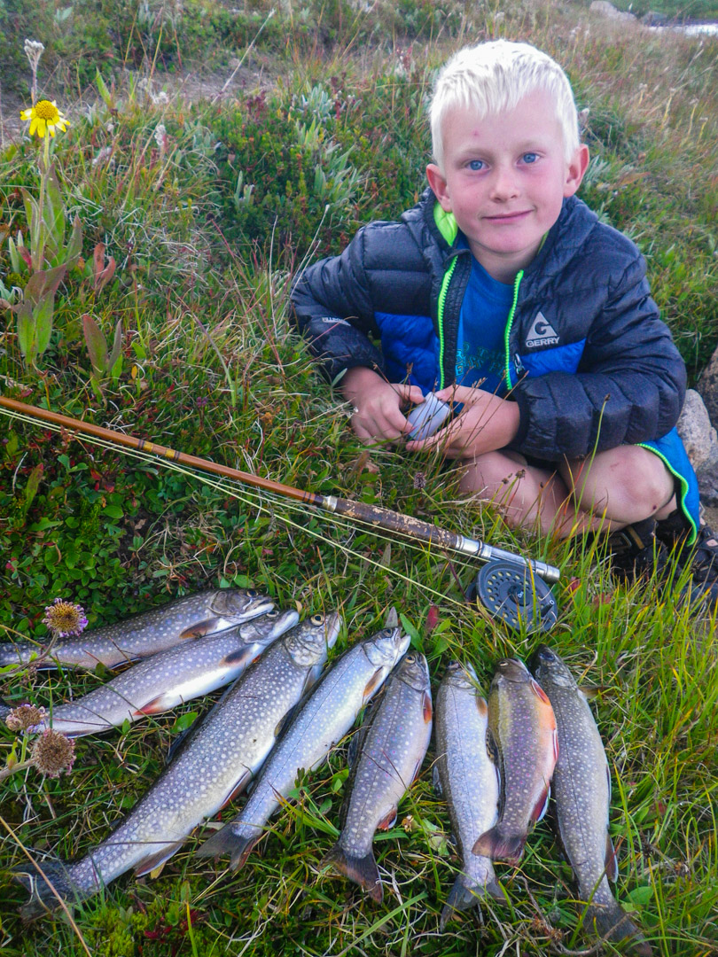 boy with brook trout rod